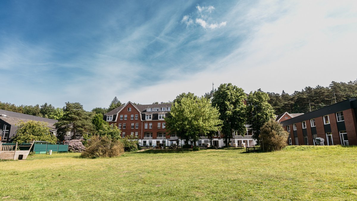 Modernes Klinikgebäude der VITREA Klinik Geesthacht umgeben von Grünflächen – Blick auf den Haupteingang der Rehabilitationsklinik